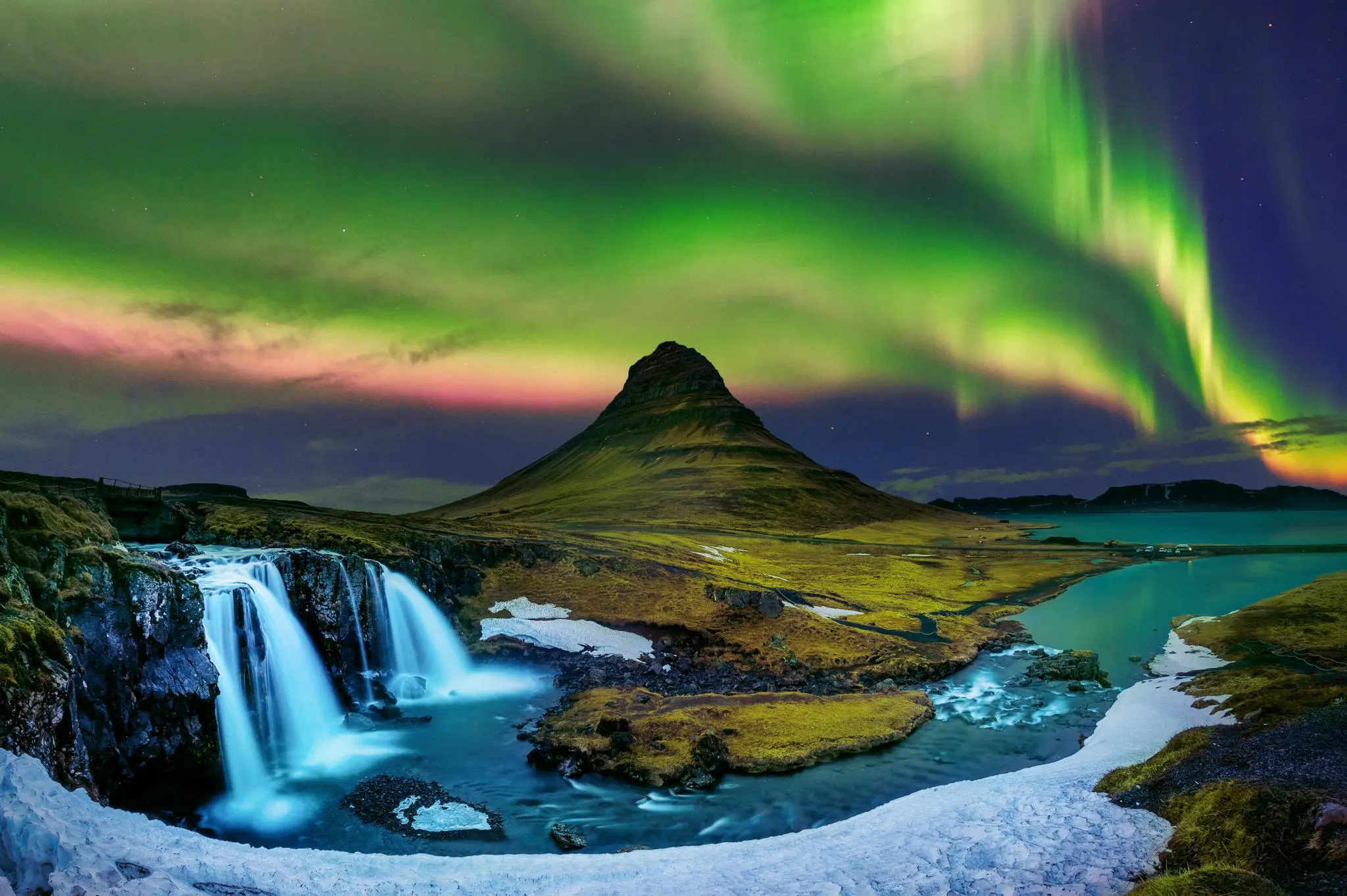 Northern Lights over Kirkjufell and its waterfall in west Iceland